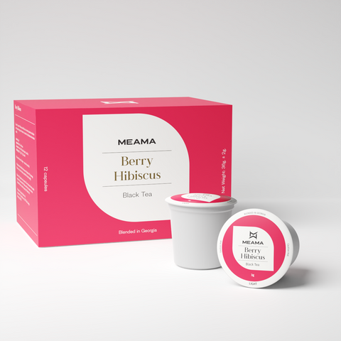 Zwei Multi-Tee-Kapseln der Sorte Berry Hibiscus stehen im Vordergrund, dahinter die passende Verpackung