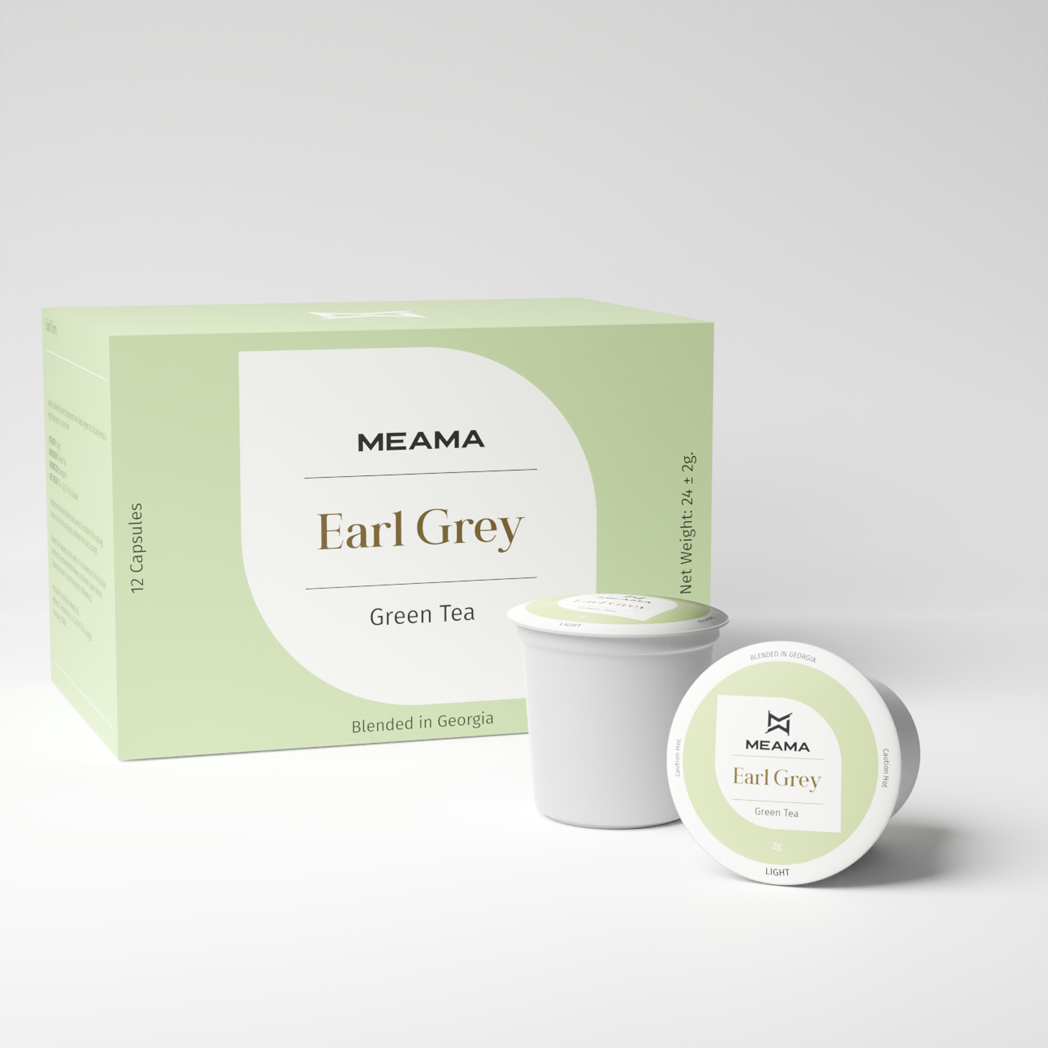 Zwei Multi-Tee-Kapseln der Sorte Earl Grey Grüntee stehen im Vordergrund, dahinter die passende Verpackung