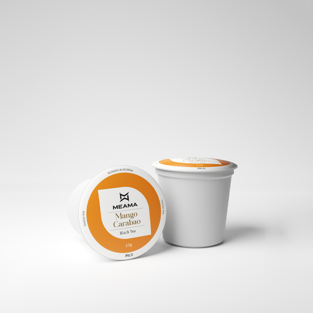 Zwei Multi-Tee-Kapseln der Sorte Mango Carabao auf weißem Hintergrund